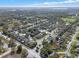 An aerial scene shows a community of well-maintained homes surrounded by lush trees and green spaces at 398 Lake Amberleigh Dr, Winter Garden, FL 34787