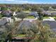 Aerial view of a home surrounded by mature trees and lush greenery and outlined in red at 398 Lake Amberleigh Dr, Winter Garden, FL 34787