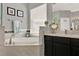 Elegant bathroom with a soaking tub, decorative tile accents, separate shower, and a vanity sink at 398 Lake Amberleigh Dr, Winter Garden, FL 34787