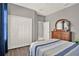 This bedroom features a double door closet, wood-look floors and a modern color palette at 398 Lake Amberleigh Dr, Winter Garden, FL 34787