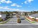 A gated community entrance featuring brick pillars, a palm tree, and neatly landscaped surroundings at 398 Lake Amberleigh Dr, Winter Garden, FL 34787