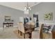 Elegant dining room featuring a wooden table, cushioned chairs, and a decorative chandelier at 398 Lake Amberleigh Dr, Winter Garden, FL 34787