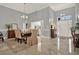 Open-concept dining area with high ceilings and elegant tile flooring at 398 Lake Amberleigh Dr, Winter Garden, FL 34787