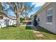 Back exterior of the property, featuring a well-maintained lawn, patio, and lovely landscaping at 398 Lake Amberleigh Dr, Winter Garden, FL 34787