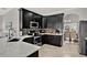 Stylish kitchen featuring dark cabinets, quartz countertops, and mosaic tile backsplash at 398 Lake Amberleigh Dr, Winter Garden, FL 34787