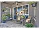 Cozy covered patio featuring neutral tile flooring, comfortable seating, and a view of the outdoor space at 398 Lake Amberleigh Dr, Winter Garden, FL 34787