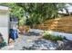 Enclosed backyard with stone pavers, wood fence, and lush tropical landscaping at 420 Sylvan Dr, Winter Park, FL 32789