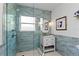 Bathroom with a glass-enclosed shower, blue tile, a single vanity, and a window for natural light at 420 Sylvan Dr, Winter Park, FL 32789