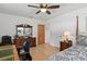 Bedroom featuring a full bed, ceiling fan, hardwood floors, writing desk, and an ensuite bathroom entrance at 420 Sylvan Dr, Winter Park, FL 32789