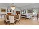 Elegant dining area with a chandelier and adjacent to a living room area at 420 Sylvan Dr, Winter Park, FL 32789