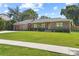 Attractive single-story home with brick exterior, well-kept lawn, and inviting curb appeal at 420 Sylvan Dr, Winter Park, FL 32789