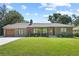 Charming brick home featuring a well-manicured lawn, brick driveway, and a classic design at 420 Sylvan Dr, Winter Park, FL 32789