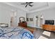 Spacious main bedroom featuring a tray ceiling, wood floors, dresser, and access to a private balcony at 420 Sylvan Dr, Winter Park, FL 32789