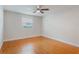 Bedroom with a fan, window and hardwood floors plus neutral walls at 4212 Lake Underhill Rd # 5, Orlando, FL 32803