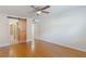 Bedroom featuring a stylish barn door, ceiling fan, and hardwood floors at 4212 Lake Underhill Rd # 5, Orlando, FL 32803