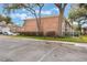 Brick building with ample parking spots, lush garden, and lots of trees at 4212 Lake Underhill Rd # 5, Orlando, FL 32803