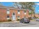 A brick two-story condo building with a reserved parking spot in front and mature landscaping at 4212 Lake Underhill Rd # 5, Orlando, FL 32803