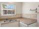 Eat-in kitchen featuring granite counters and stainless steel sink underneath a window at 4212 Lake Underhill Rd # 5, Orlando, FL 32803