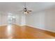 Bright living room with fan, hardwood floors and neutral walls leading into a kitchen area at 4212 Lake Underhill Rd # 5, Orlando, FL 32803