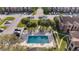 Aerial view of community pool surrounded by trees and apartment buildings at 4367 Thornbriar Ln # P204, Orlando, FL 32822