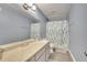 Bathroom featuring a single sink vanity and shower with tiled walls and a matching shower curtain at 4367 Thornbriar Ln # P204, Orlando, FL 32822