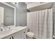 Clean bathroom features a shower-tub combo with a patterned curtain and a modern white vanity sink at 4367 Thornbriar Ln # P204, Orlando, FL 32822