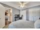 Comfortable bedroom featuring neutral gray walls, ceiling fan, and a desk setup ideal for a home office at 4367 Thornbriar Ln # P204, Orlando, FL 32822