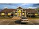 Evening view of the community clubhouse showing illuminated exterior with a well-lit parking area at 4367 Thornbriar Ln # P204, Orlando, FL 32822