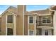 A close up view of a condo with tan siding, brick accents, and cozy balconies at 4367 Thornbriar Ln # P204, Orlando, FL 32822