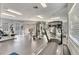 Spacious gym with mirrored wall, providing a variety of machines and equipment at 4367 Thornbriar Ln # P204, Orlando, FL 32822