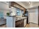 Kitchen featuring granite countertops, dark wood cabinets, and stainless steel appliances at 4367 Thornbriar Ln # P204, Orlando, FL 32822