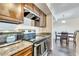 View of the kitchen featuring granite counters, stainless appliances, and modern microwave at 4367 Thornbriar Ln # P204, Orlando, FL 32822