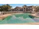 Community pool with brick trimmed deck, surrounded by apartment building and a white fence at 4367 Thornbriar Ln # P204, Orlando, FL 32822