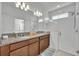 Modern bathroom featuring a double vanity, granite countertops, and a glass-enclosed shower at 4426 Davos Dr, Clermont, FL 34711