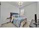 Comfortable bedroom with a blue comforter, side tables, and natural light at 4426 Davos Dr, Clermont, FL 34711