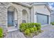 The attractive home entrance features beautiful stone accents and a welcoming covered front porch at 4426 Davos Dr, Clermont, FL 34711