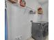 Functional laundry room with modern washer and dryer and shelving for storage at 4426 Davos Dr, Clermont, FL 34711