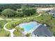 Stunning aerial view of community pool with lounge chairs and lush landscaping at 4426 Davos Dr, Clermont, FL 34711