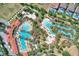 Aerial view of a community pool, water slide, and lazy river surrounded by green space at 4607 Terrasonesta Dr, Davenport, FL 33837