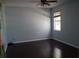 Bedroom with dark wood floors, a window, and overhead ceiling fan with lighting at 4650 Redmond Pl, Sanford, FL 32771