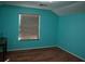 Bright bedroom featuring hard wood floors, a window and vibrant paint at 4650 Redmond Pl, Sanford, FL 32771