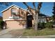 Charming two-story home with a well-maintained front lawn and inviting entryway with attractive beige and white color scheme at 4650 Redmond Pl, Sanford, FL 32771