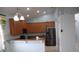 Kitchen with granite countertops, stainless steel appliances, and wooden cabinetry in an open-concept space at 4650 Redmond Pl, Sanford, FL 32771