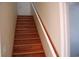 Wooden staircase with painted risers and a handrail, leading to the upper level at 4650 Redmond Pl, Sanford, FL 32771