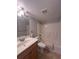 Well-maintained bathroom featuring a shower-tub combination and a wood vanity with sink at 4822 Conway Rd # 125, Orlando, FL 32812