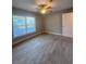 Comfortable bedroom with light floors, a ceiling fan, a window, and a closet at 4822 Conway Rd # 125, Orlando, FL 32812