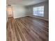 Spacious living room features attractive wood flooring, built-in storage, and lots of natural light at 4822 Conway Rd # 125, Orlando, FL 32812