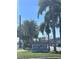 Sienna Place Condominiums sign surrounded by beautiful palm trees under a clear blue sky at 4822 Conway Rd # 125, Orlando, FL 32812