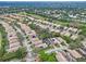 Aerial view of a residential neighborhood featuring well-maintained homes, trees, and a golf course at 501 Sotheby Way, Debary, FL 32713