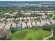 Aerial view of a beautiful residential area next to a golf course, featuring houses with backyard pools at 501 Sotheby Way, Debary, FL 32713